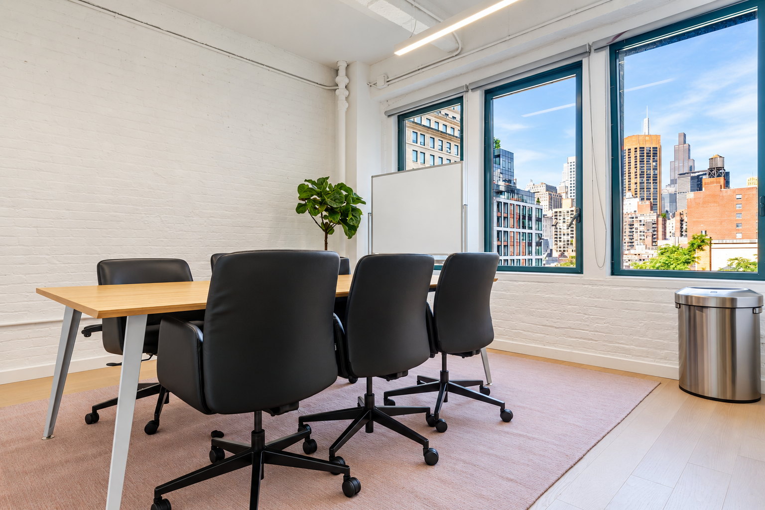 Seventh floor meeting room with painted brick walls and windows over the rooftops